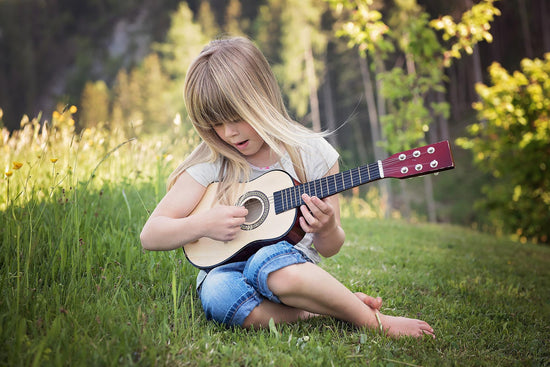 child playing ukelele