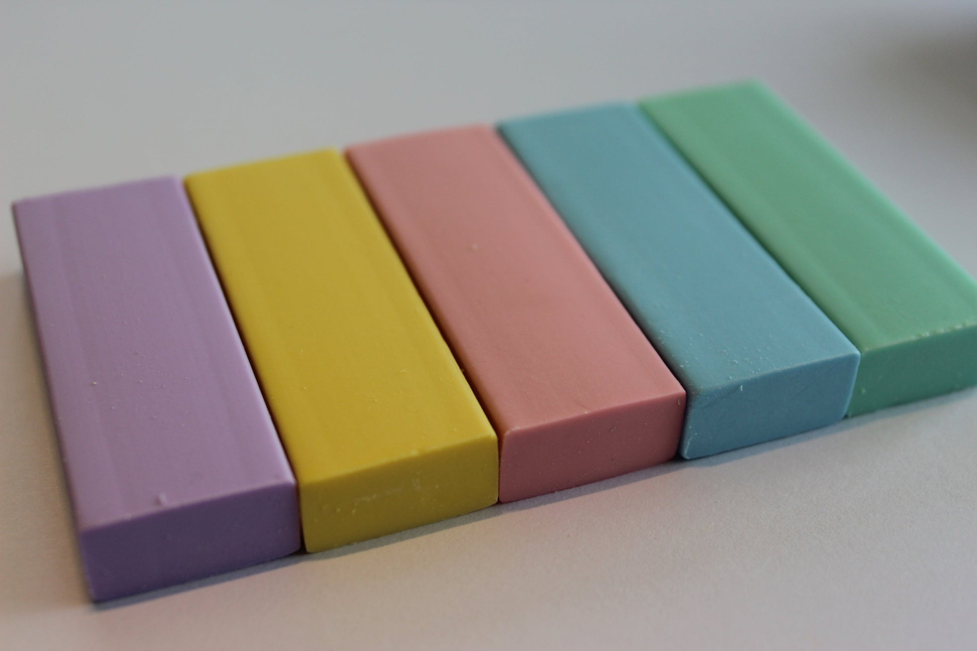 5 pastel rubbers in purple, yellow, pink, blue and green.