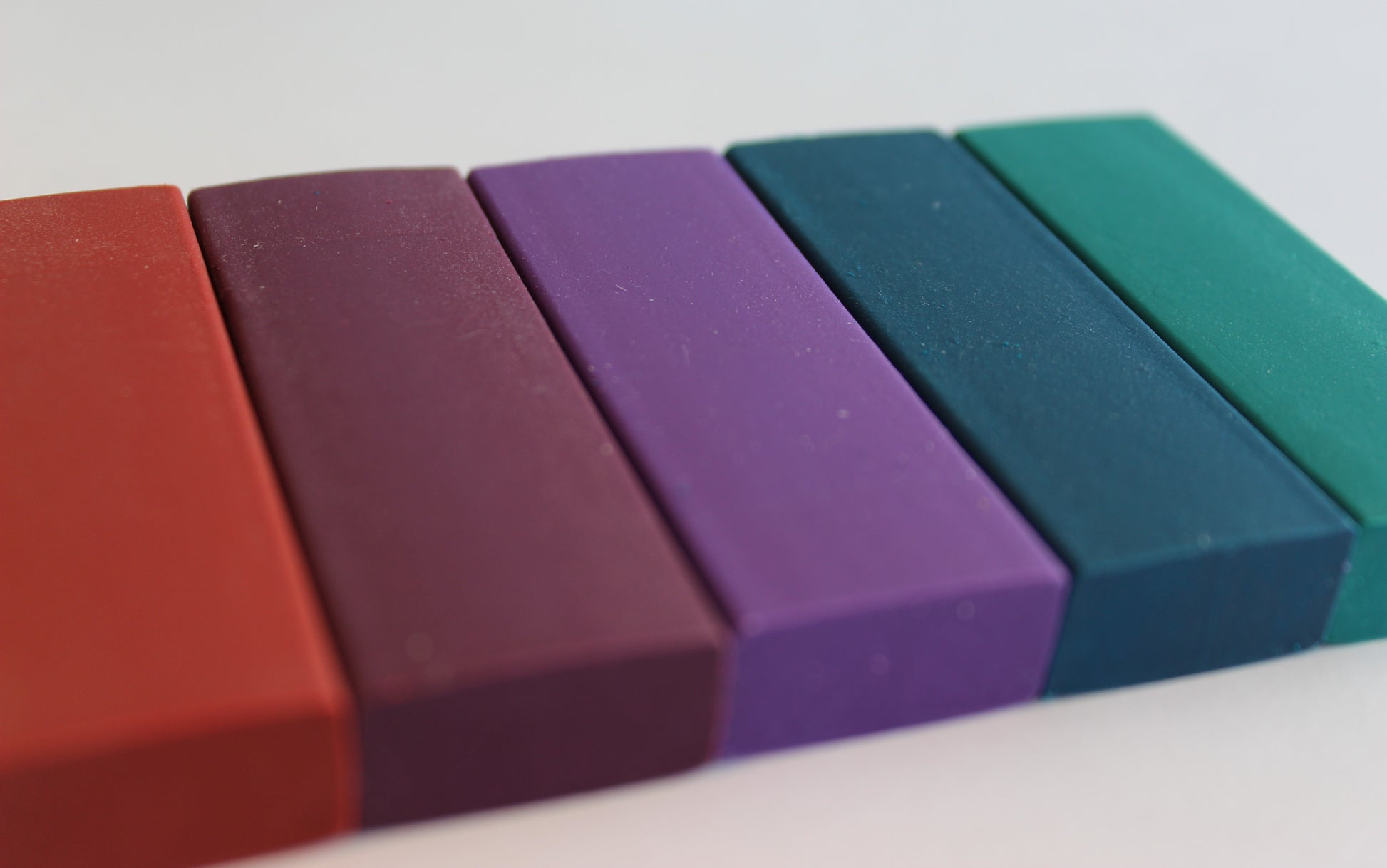 A pack of midnight shades of rubbers; red, purple, mauve, blue and turquoise