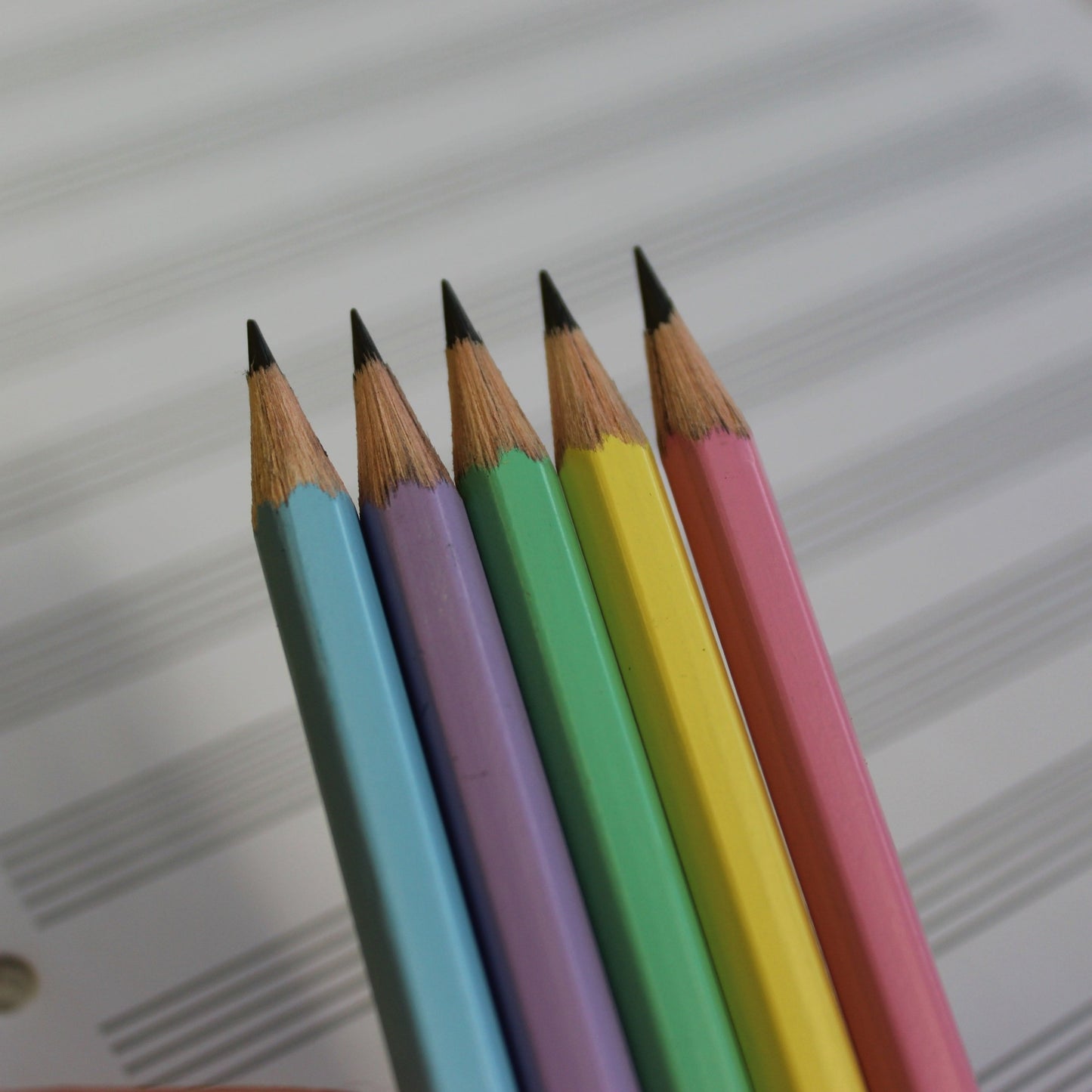 Photo shows the colour of the pastel pencils clearly; blue, purple, green, yellow and pink.