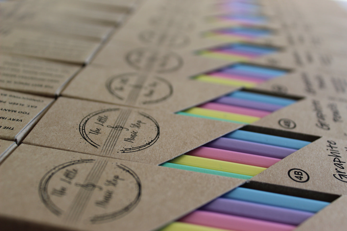 Kraft boxes displaying pastel coloured pencils inside.