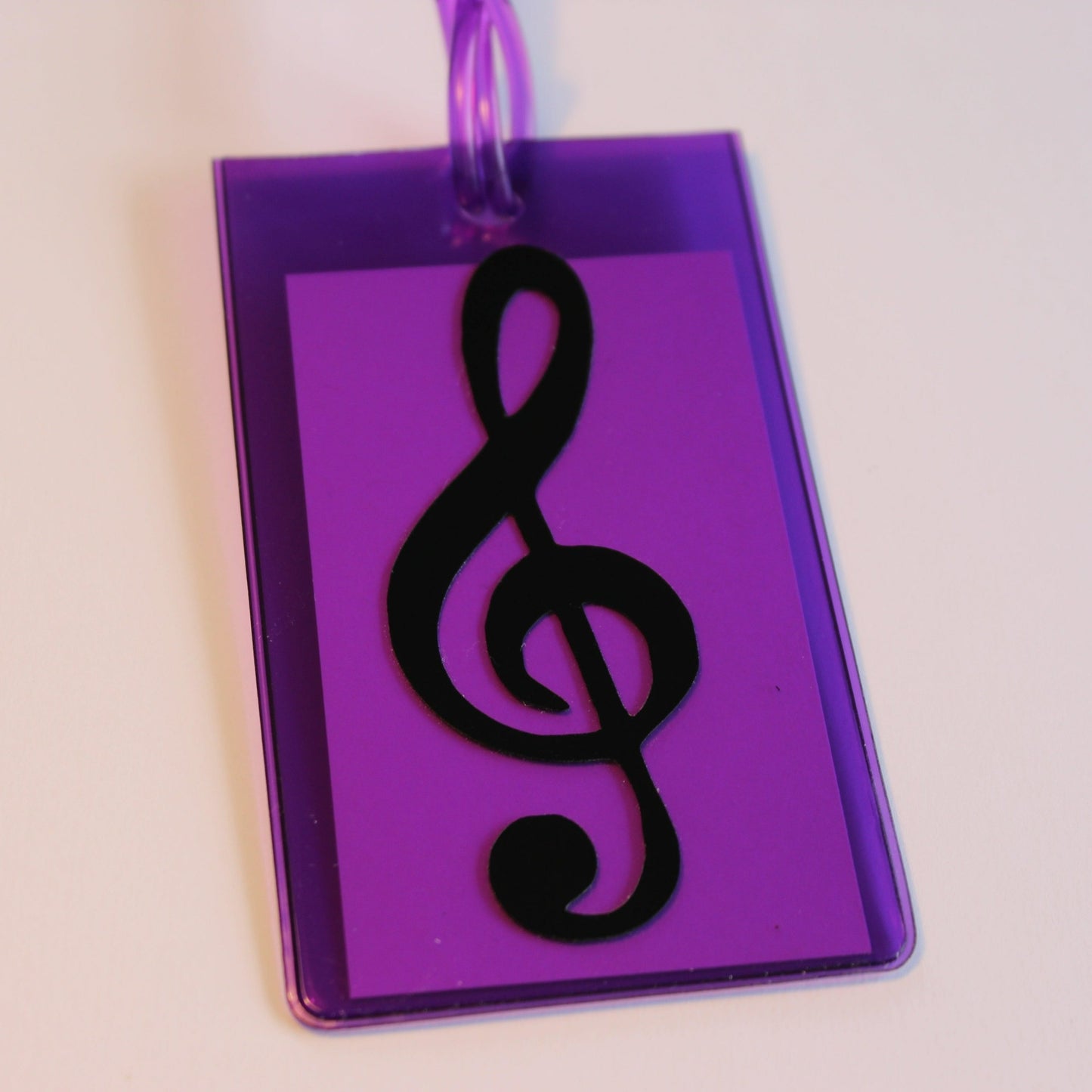 Purple instrument tag with black treble clef.