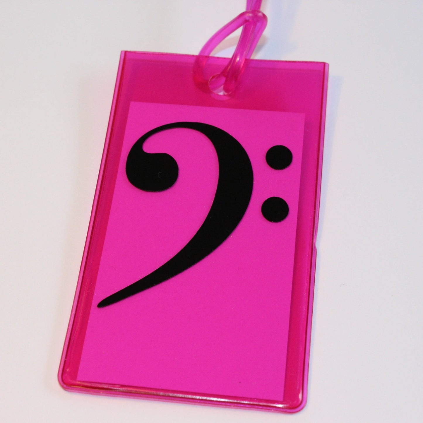 Pink instrument tag with black bass clef.