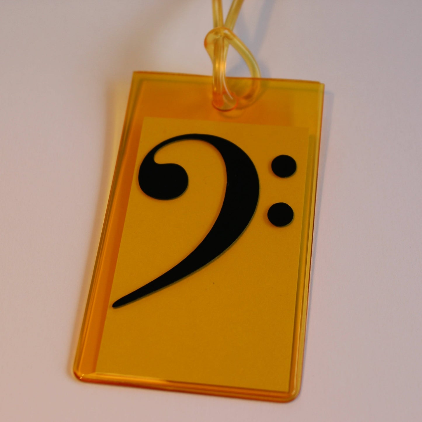 Orange instrument tag with black bass clef.