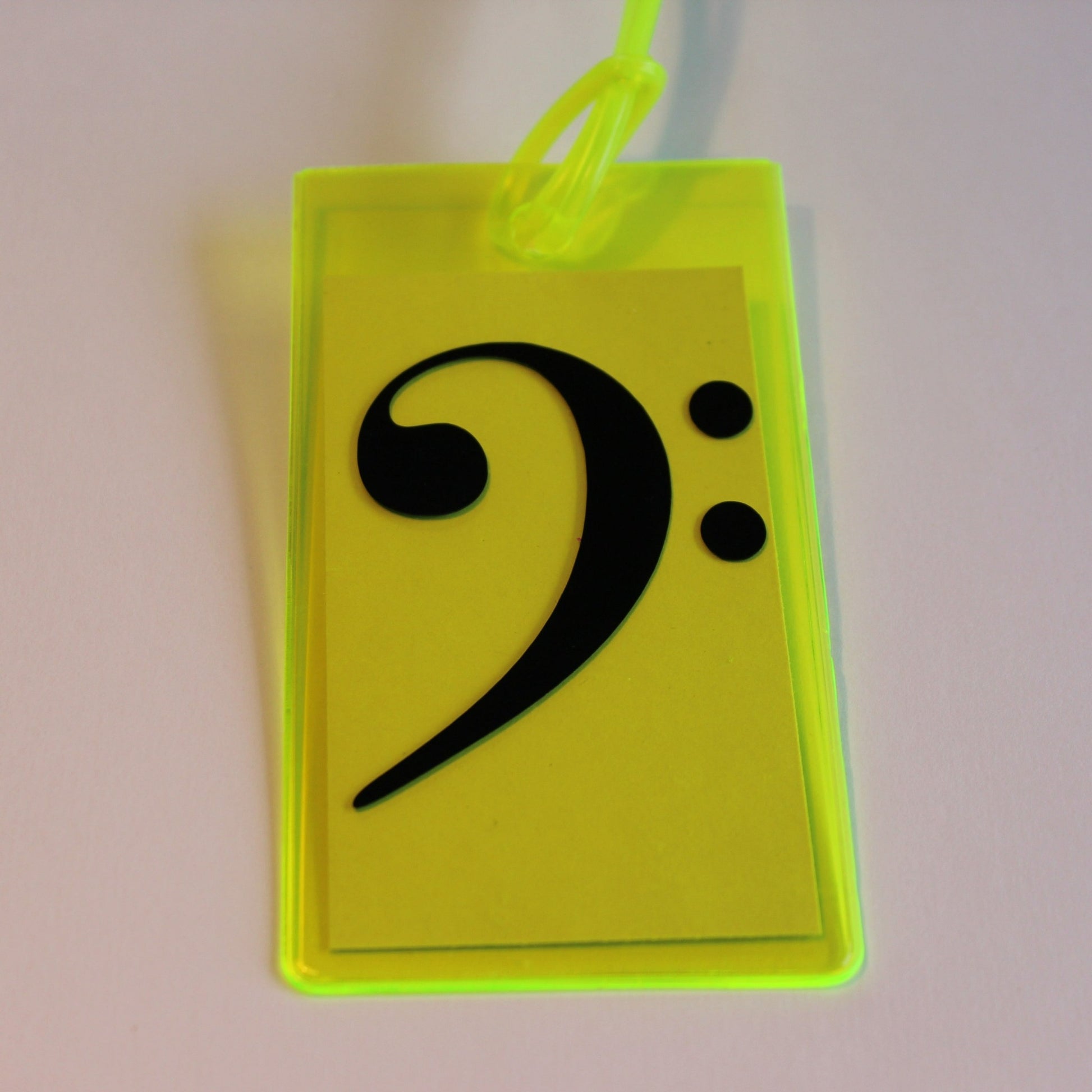 Neon yellow instrument tag with black bass clef.