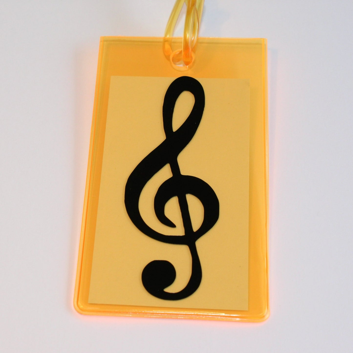 Neon orange instrument tag with black treble clef.